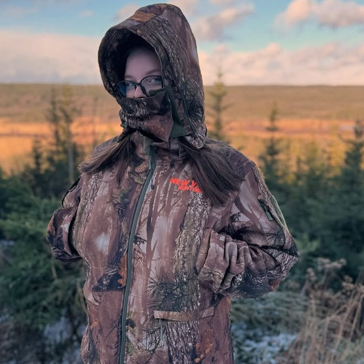 Woman wearing camouflage hunting clothing in the field
