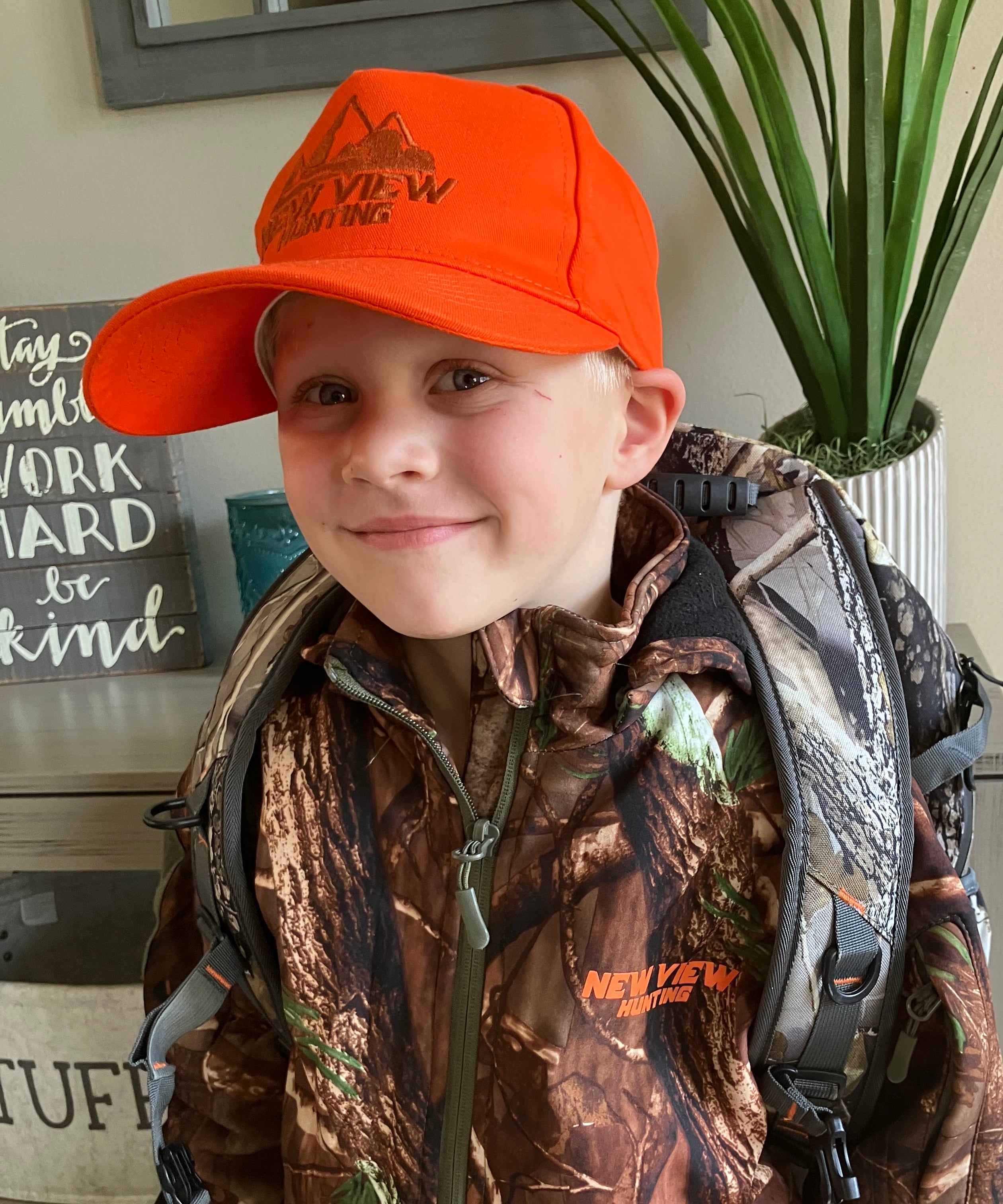 a boy and his 30L camo hunting backpack